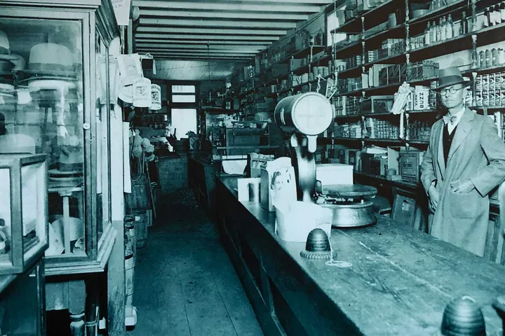 c. 1910: John Louis “Deed” Smith behind the counter at H.J. Smith’s Son Store, established in 1876.