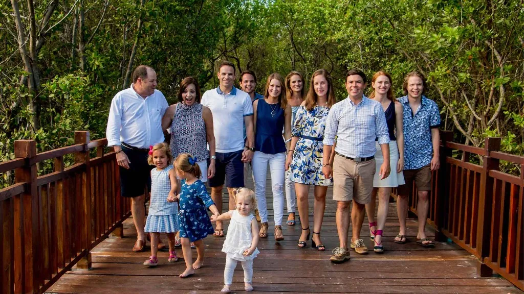 Mayor Mark Johnson walking with his family on a boardwalk near Covington